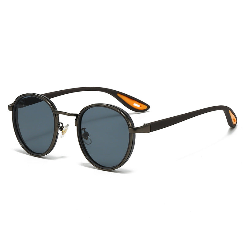 Vintage designer outdoor sunglasses featuring a stylish round frame with dark lenses and unique colored temple tips.